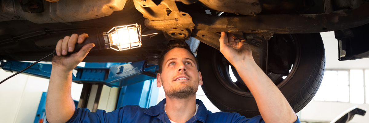 A mechanic inspecting underneath a vehicle - MOT Tonbridge